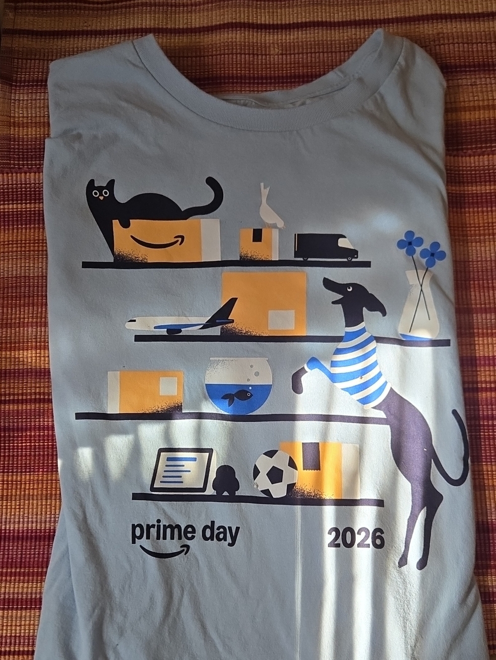 Amazon Light Blue Graphic Tee with Navy and Yellow Package Motif